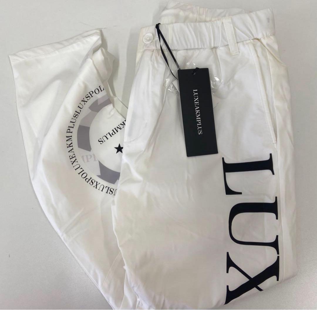 リュクスエイケイエムプラス ゴルフ 防風 サークルロゴウィンドウパンツ＆ウェア