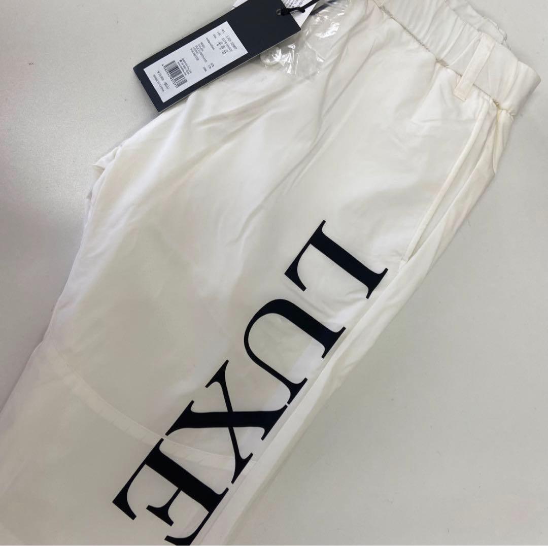 リュクスエイケイエムプラス ゴルフ 防風 サークルロゴウィンドウパンツ＆ウェア