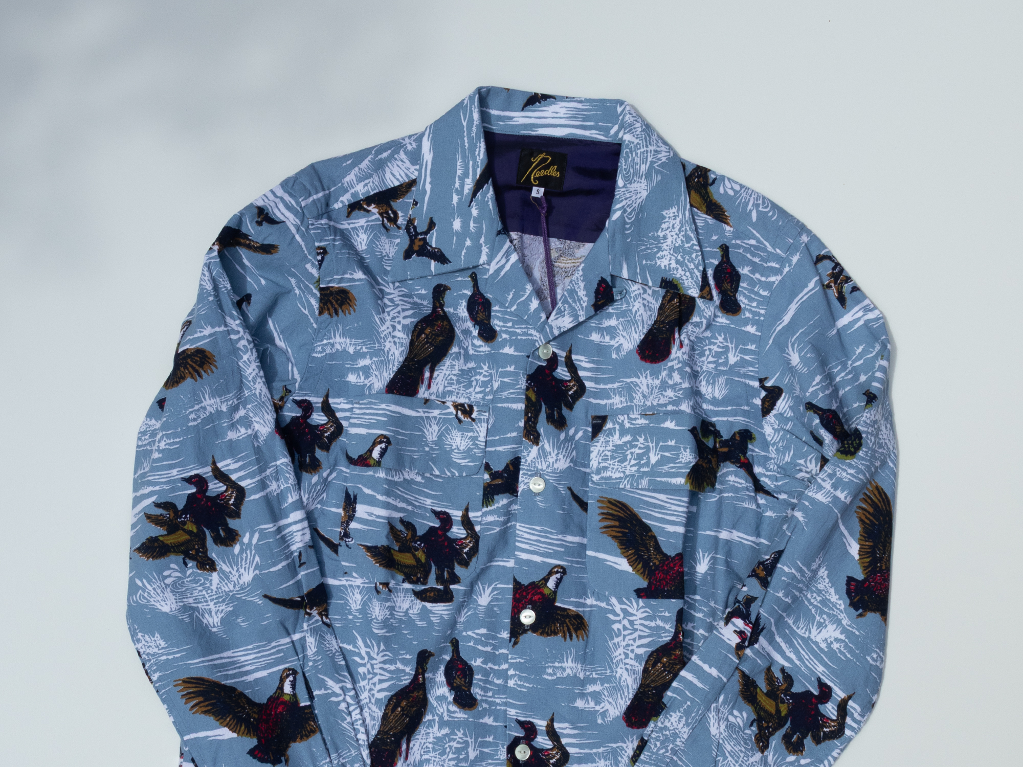 A CLASSIC SHIRT that embodies NEEDLES' playful spirit and American